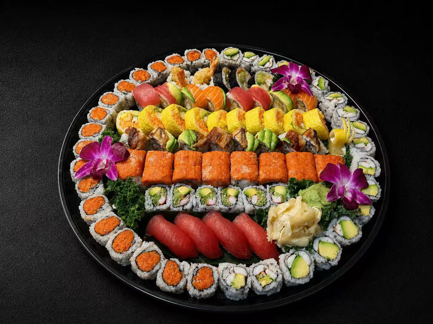 Large sushi platter with assorted rolls, nigiri, and decorative orchids at Wasu Sushi Ramen, a Sushi restaurant in Bedminster